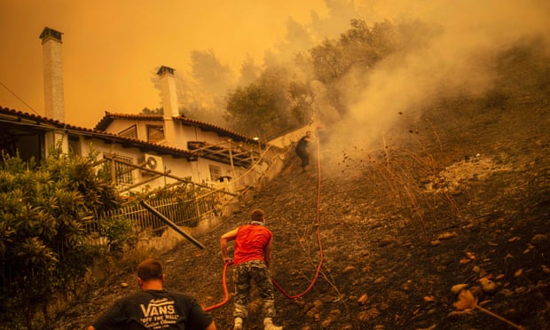 Thousands flee Greek island as wildfires raze forest and homes