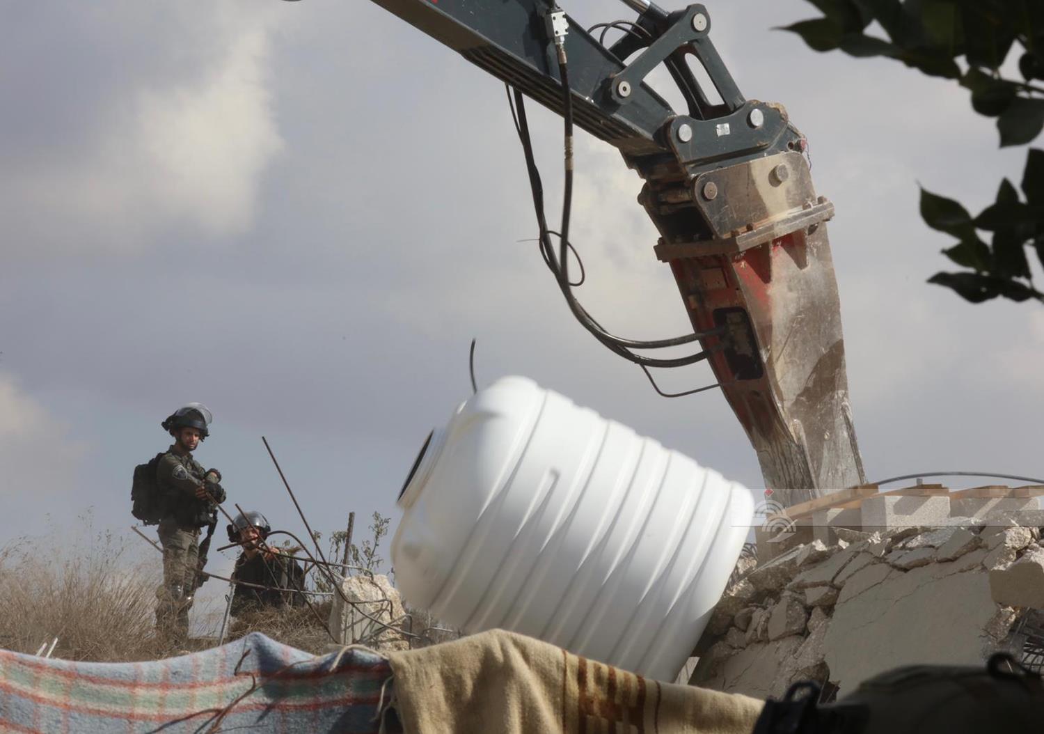 Israeli occupation forces demolish parts of a home in Nablus