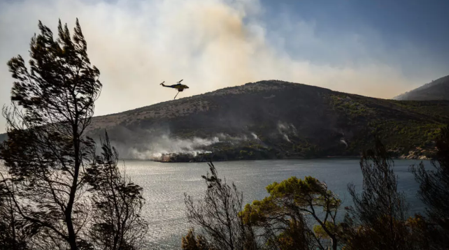 Two dead, hundreds evacuated from fires on island near Athens